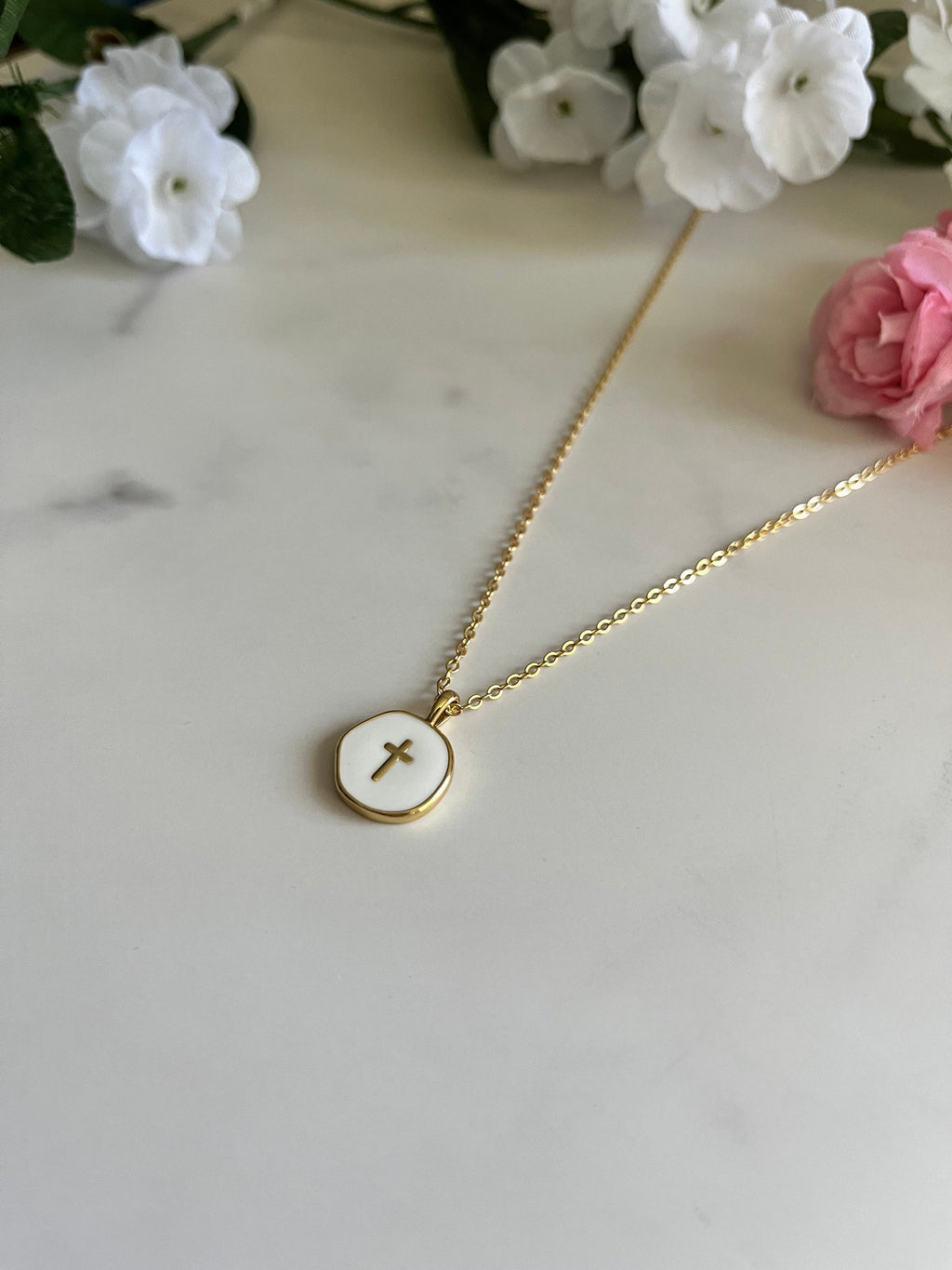 Gold cross pendant necklace with round disc and thin chain