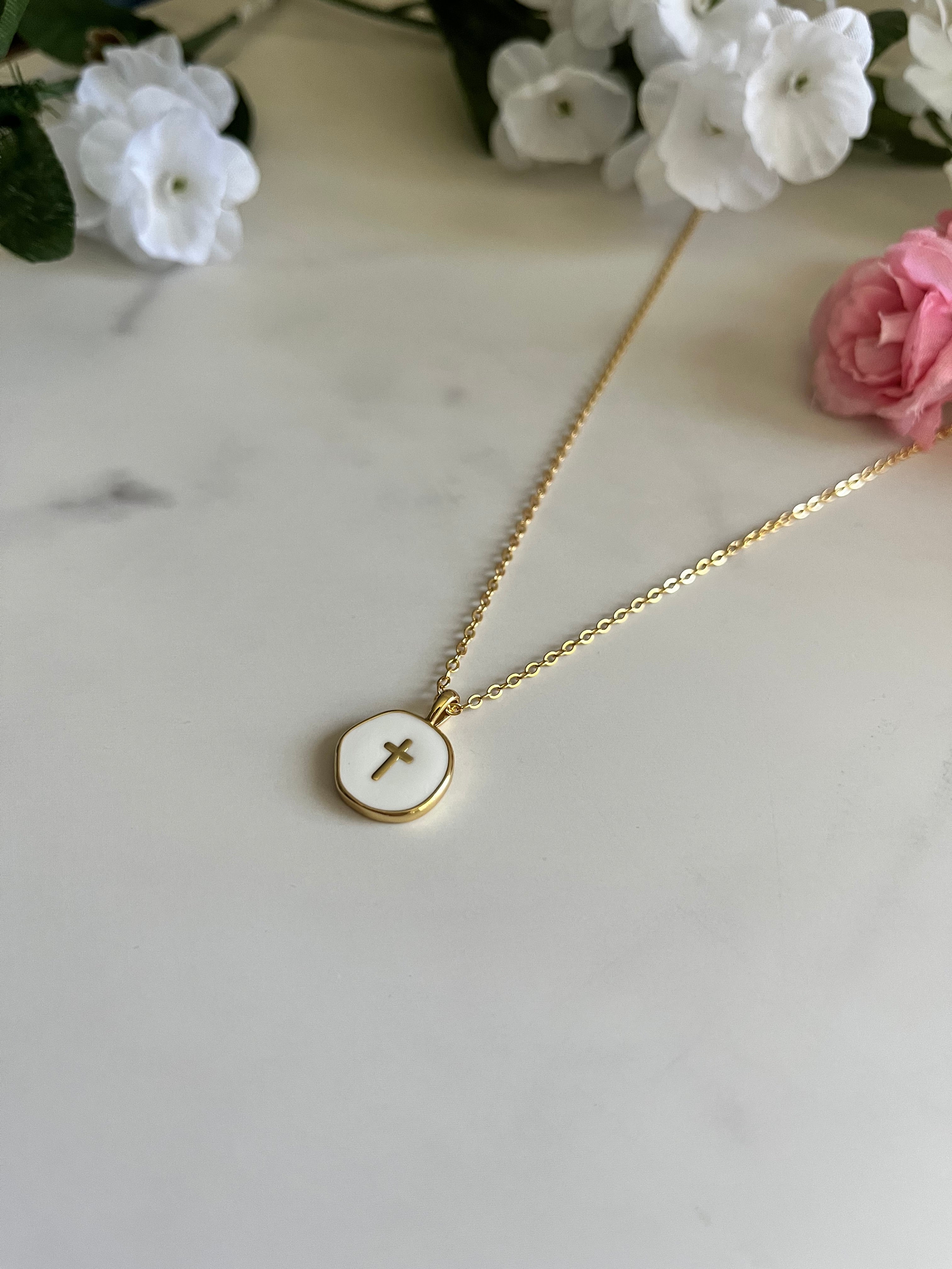 Gold cross pendant necklace with round disc and thin chain