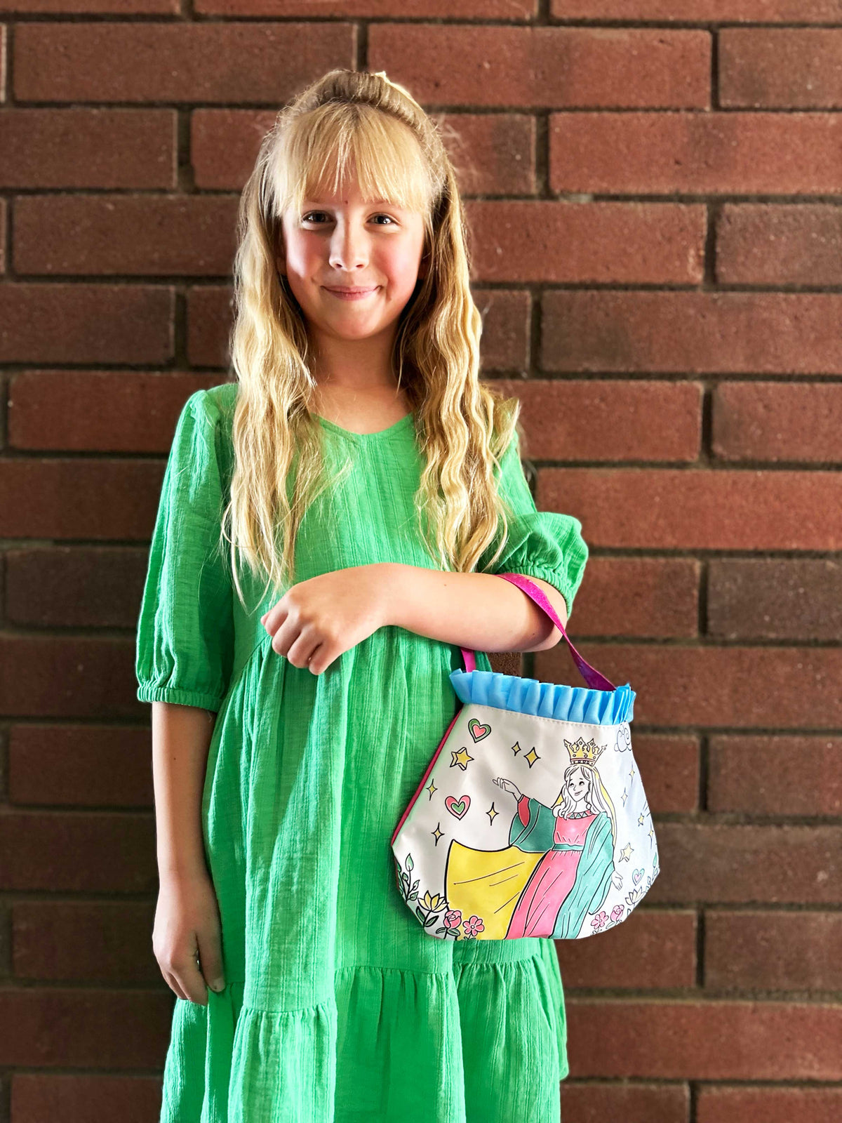 Mary themed color and pray purse with blue ruffled top, child holding it