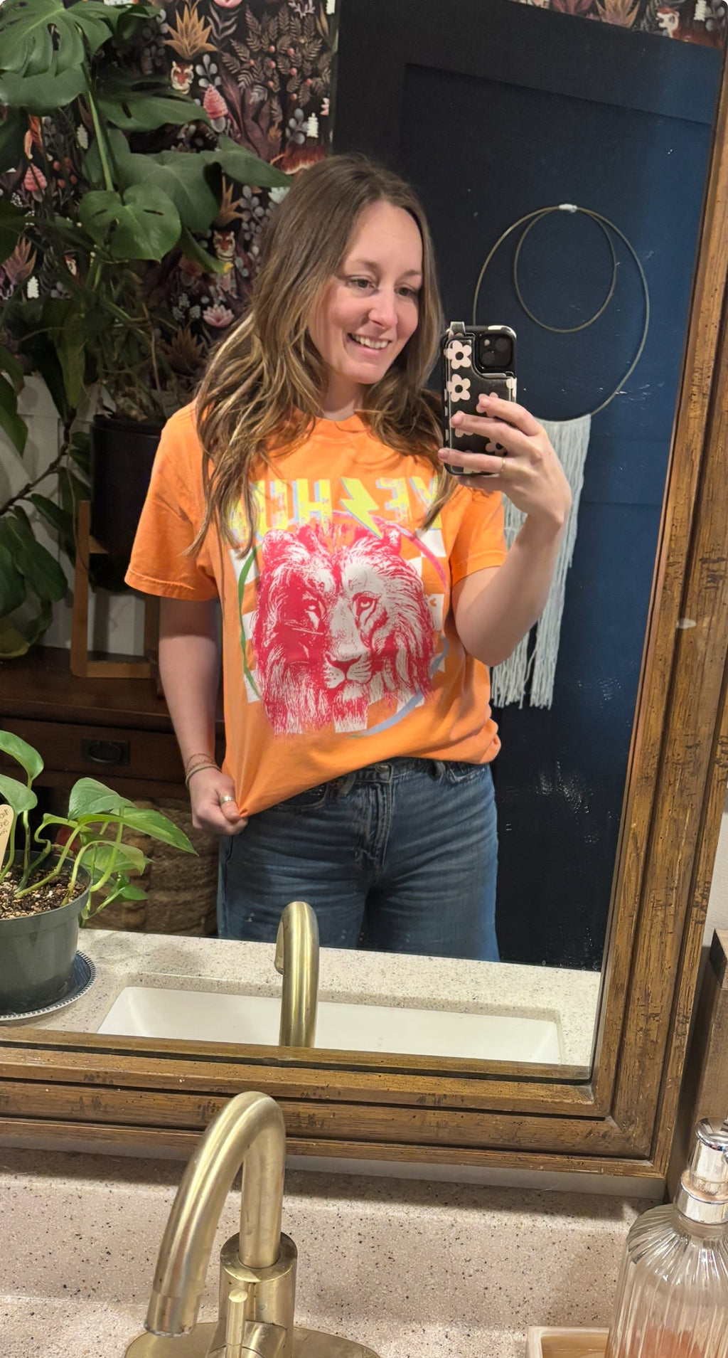 Orange t-shirt with red lion graphic and colorful faith-style lettering