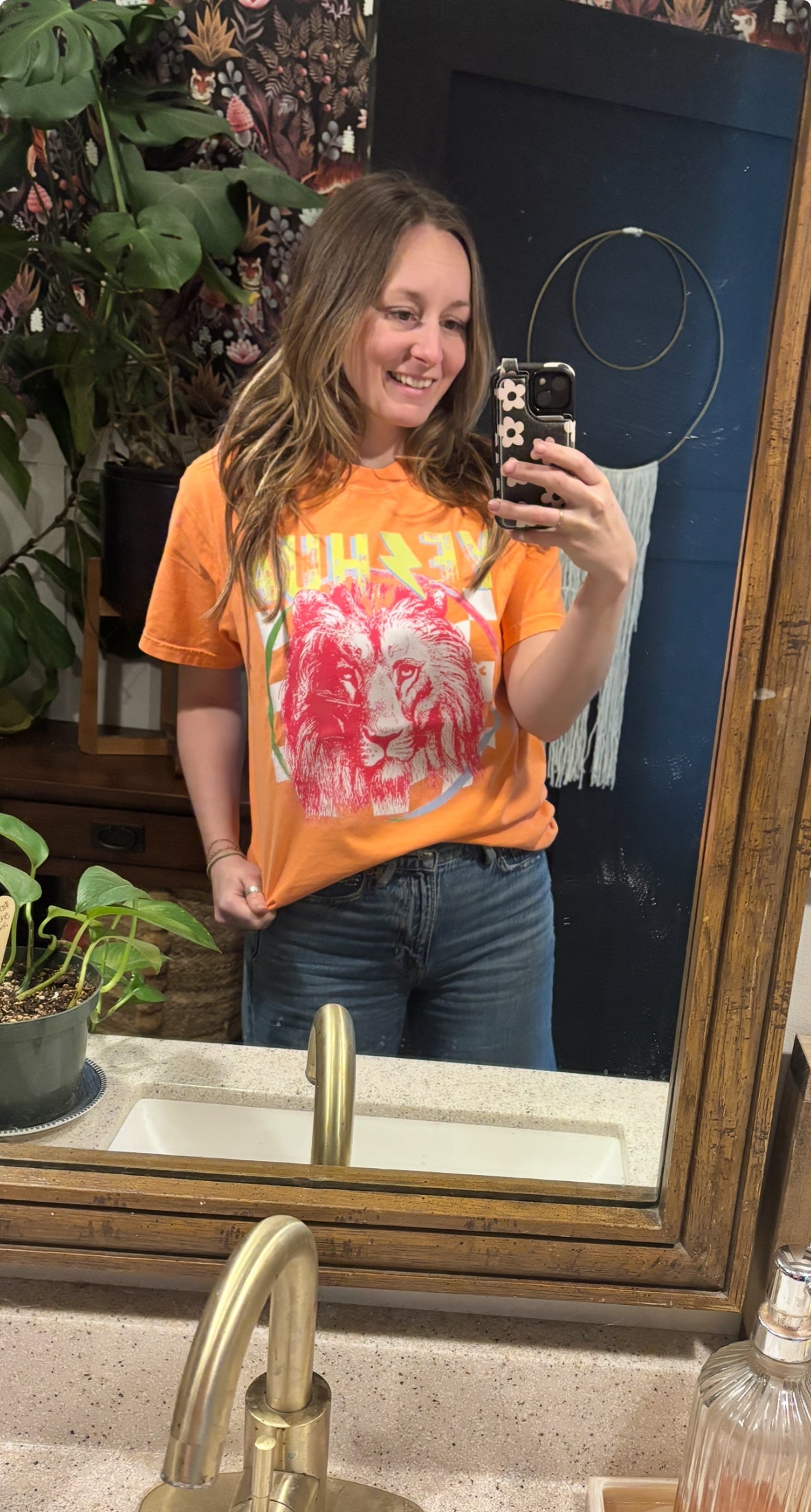 Orange t-shirt with red lion graphic and colorful faith-style lettering
