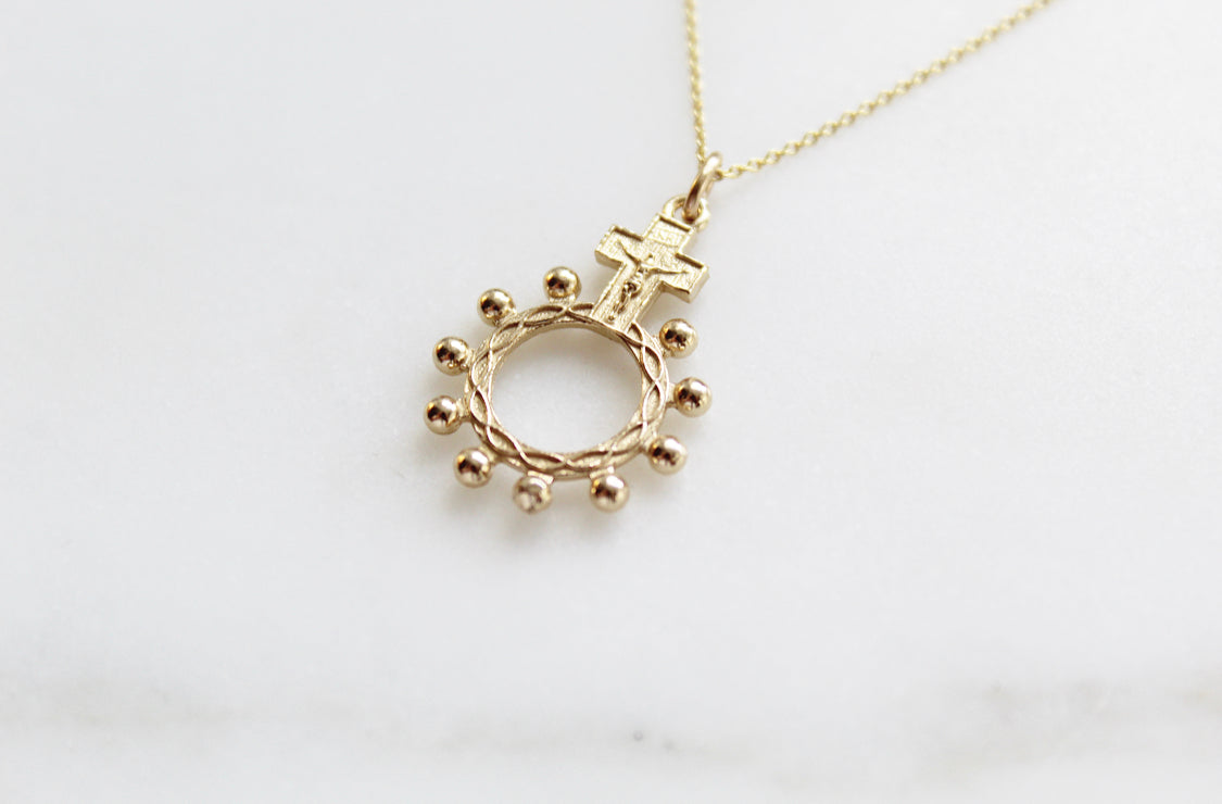 14k gold rosary bead necklace pendant showing circular ring with bead drops and a cross