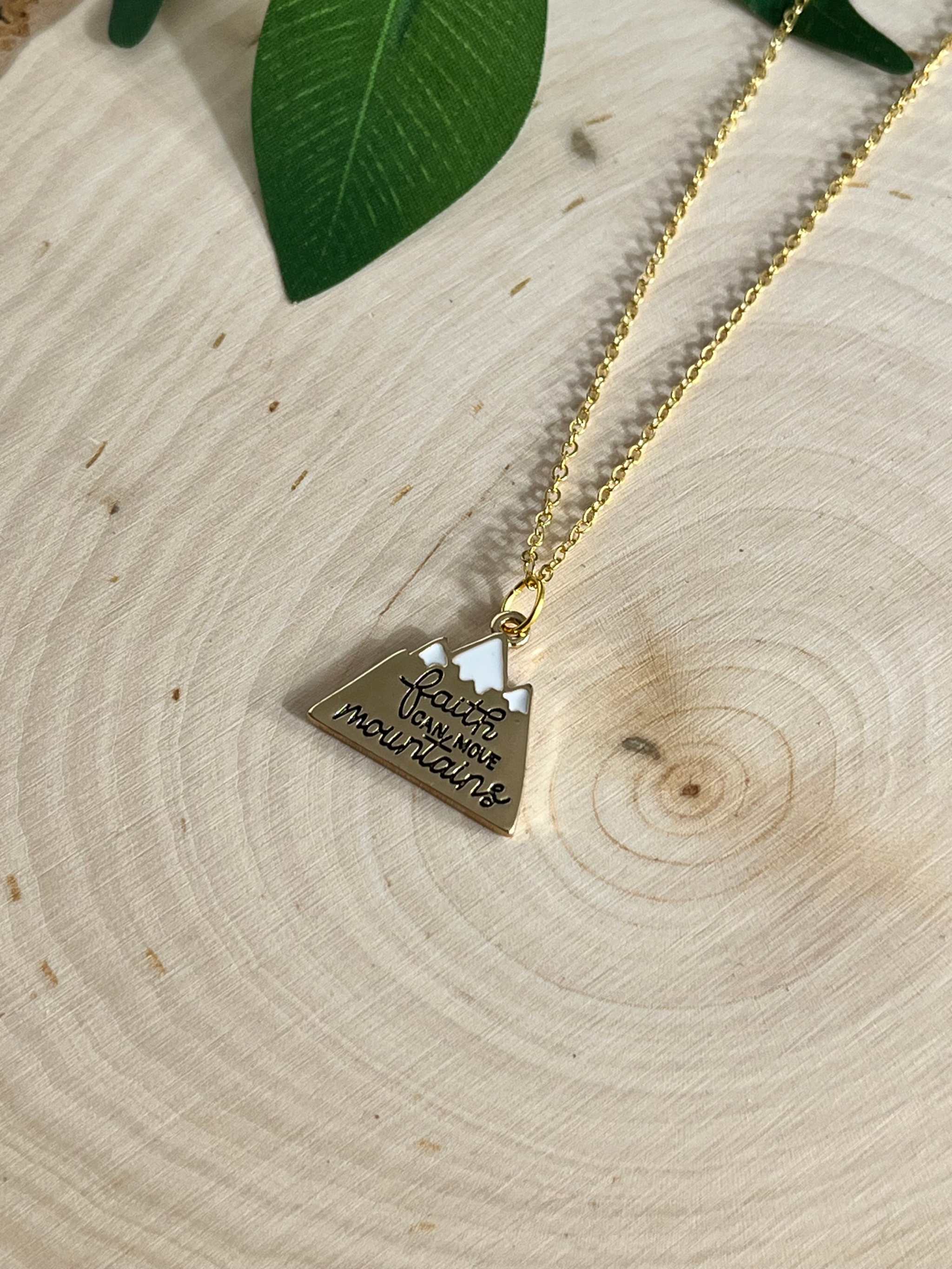 Gold chain necklace with heart-shaped pendant engraved with scripture text