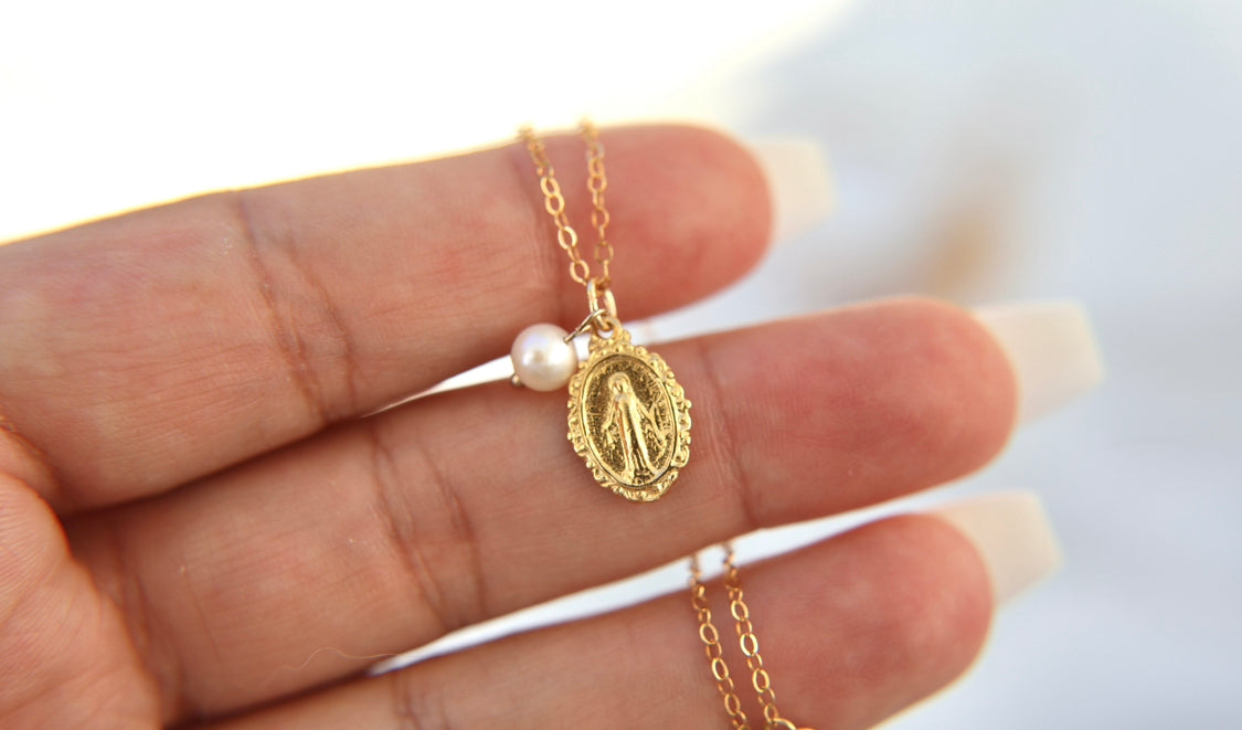 Gold-tone miraculous medal necklace with pearl drop and oval filigree pendant