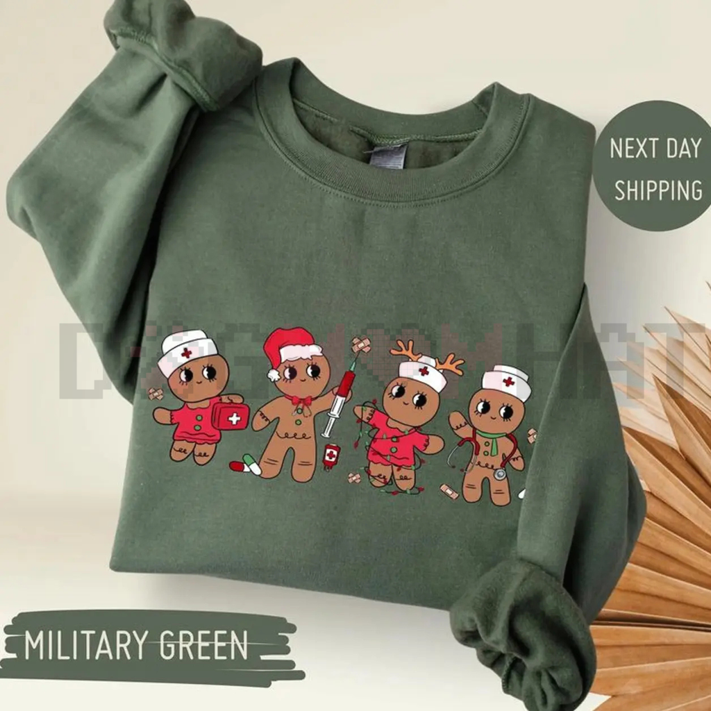 Military green sweatshirt with cartoon gingerbread nurse characters graphic on front, crew neck