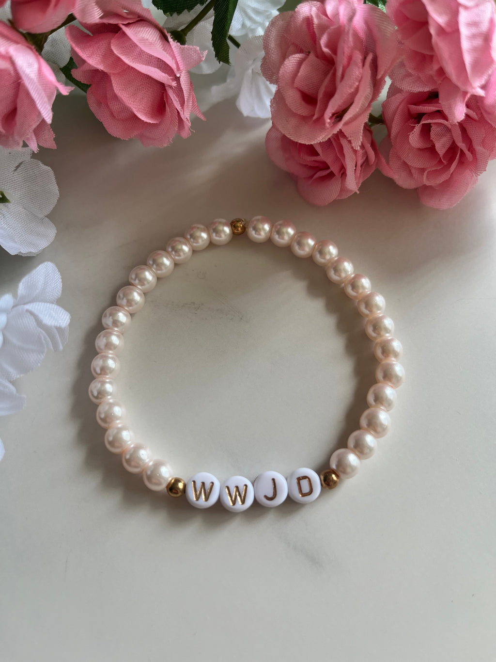 Pink pearl bead bracelet with WWJD letter beads and small gold accents