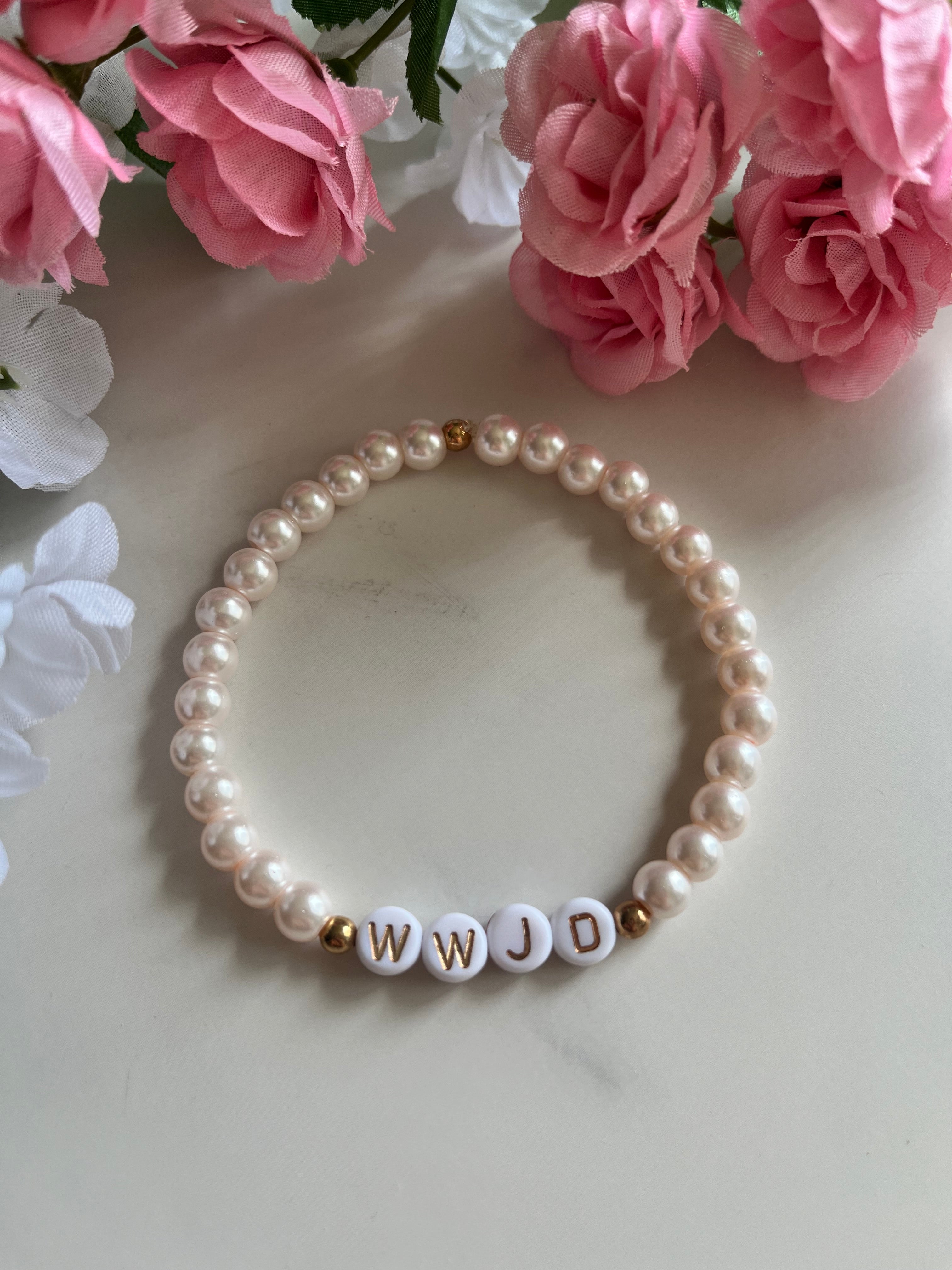 Pink pearl bead bracelet with WWJD letter beads and small gold accents