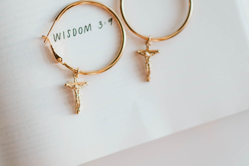 Gold-tone hoop earrings with crucifix cross charm
