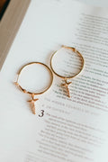 Gold-tone hoop earrings with dangling crucifix cross charm