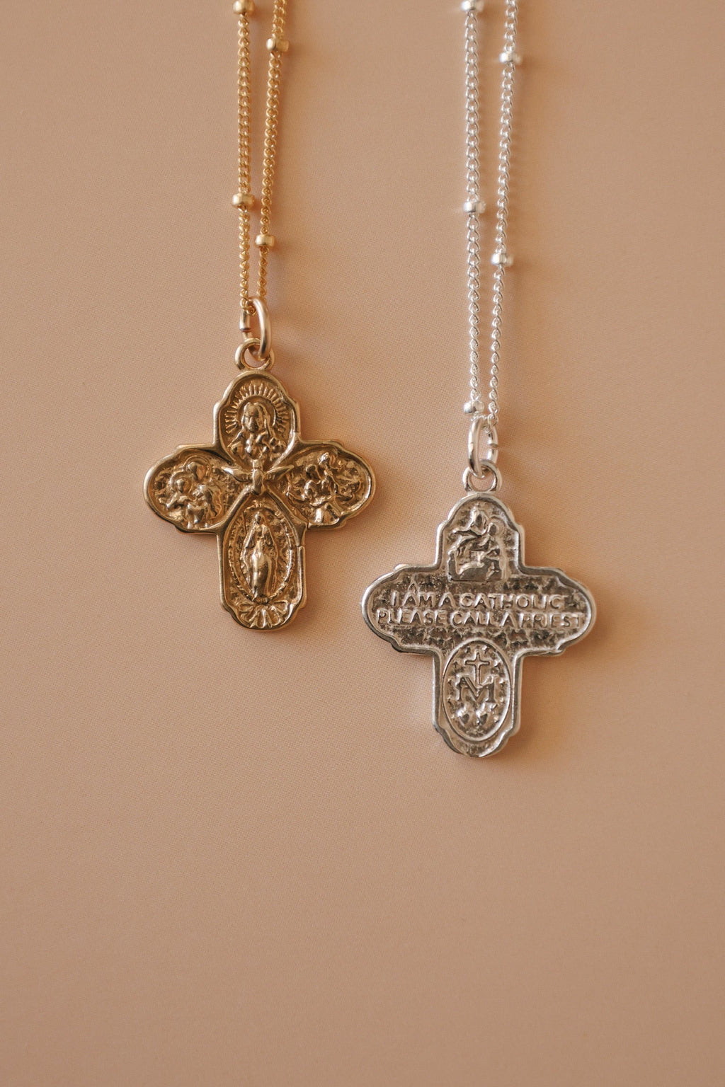 Pair of cross necklaces with gold and silver filigree pendants on beaded chains