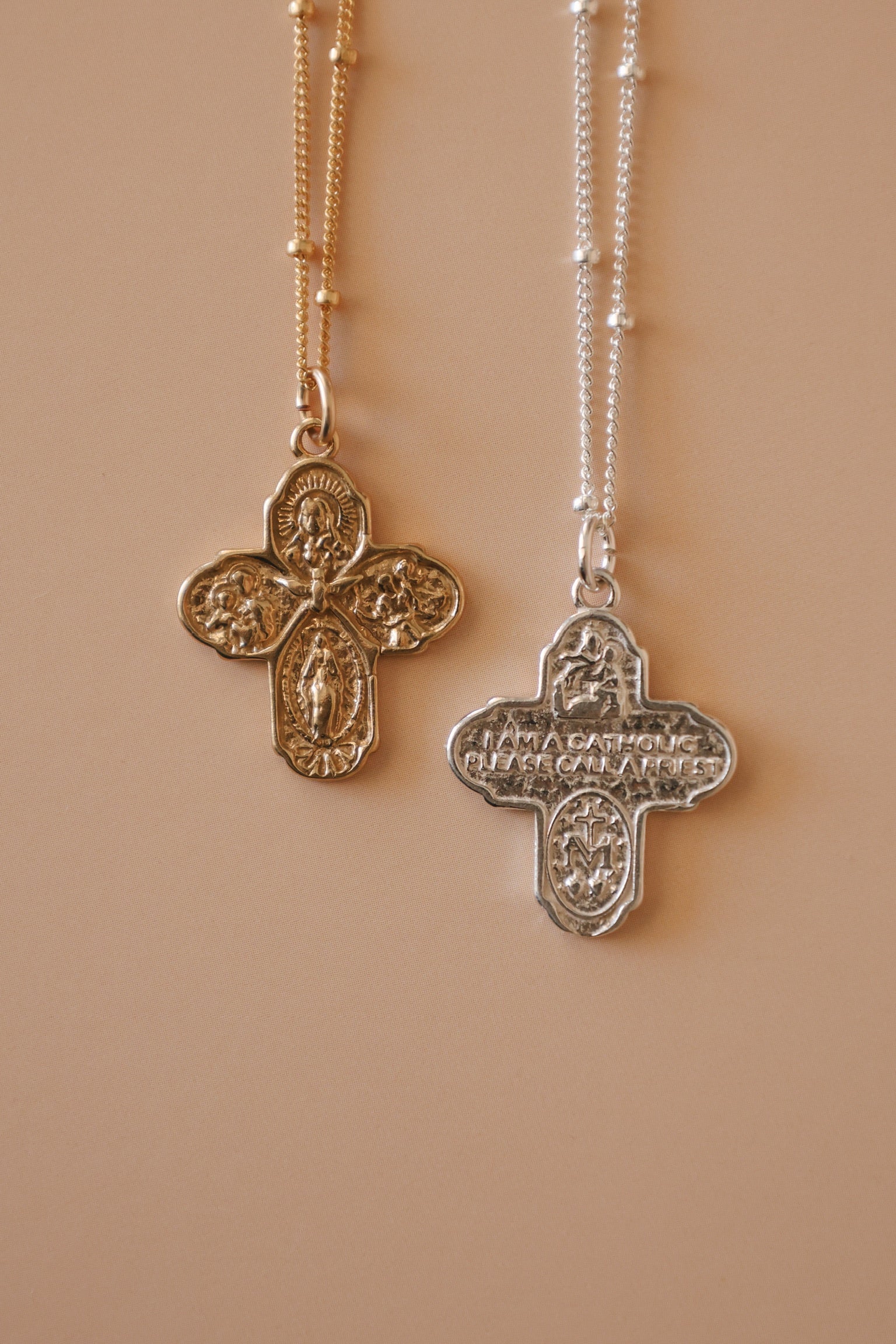 Pair of cross necklaces with gold and silver filigree pendants on beaded chains