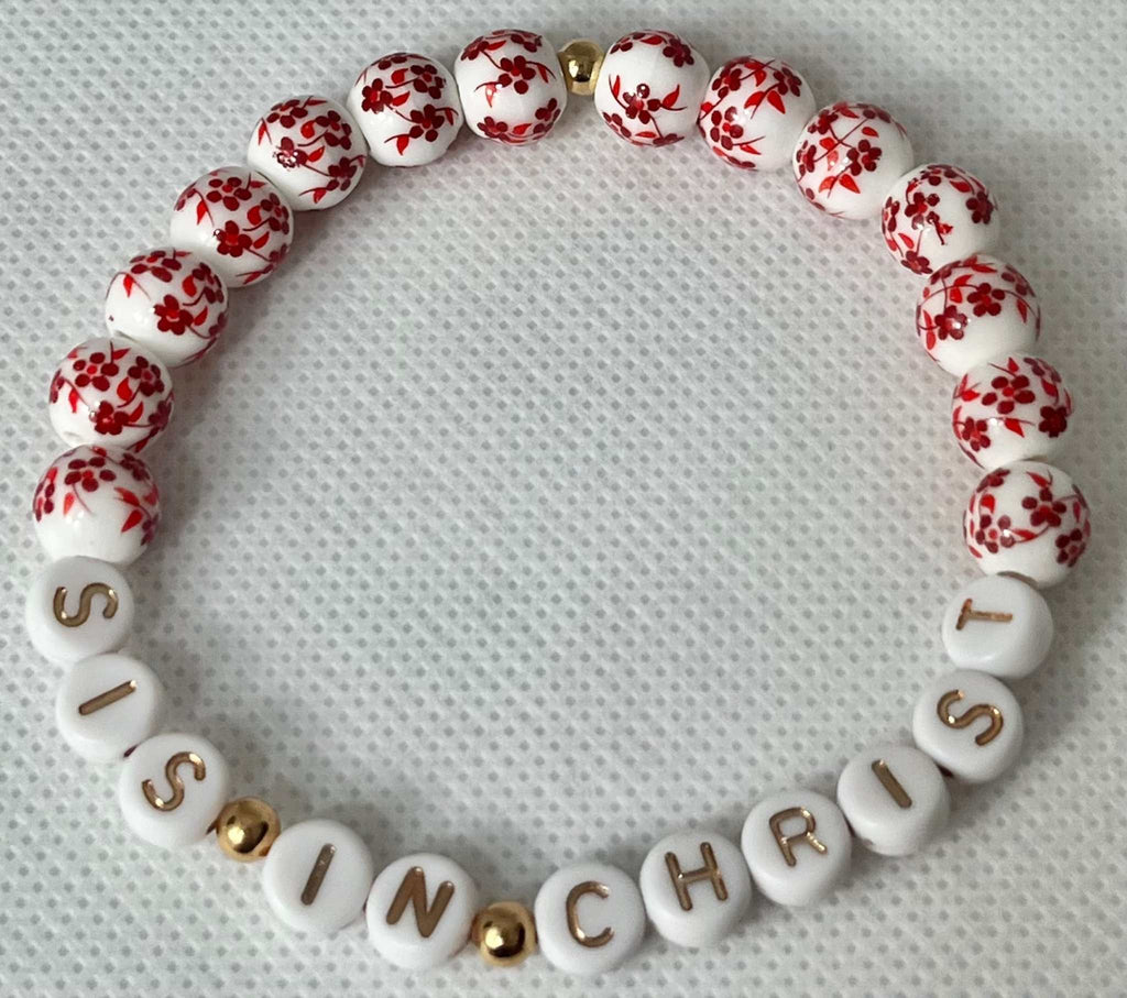 Red and white bead bracelet with gold spacers and letters spelling IN CHRIST