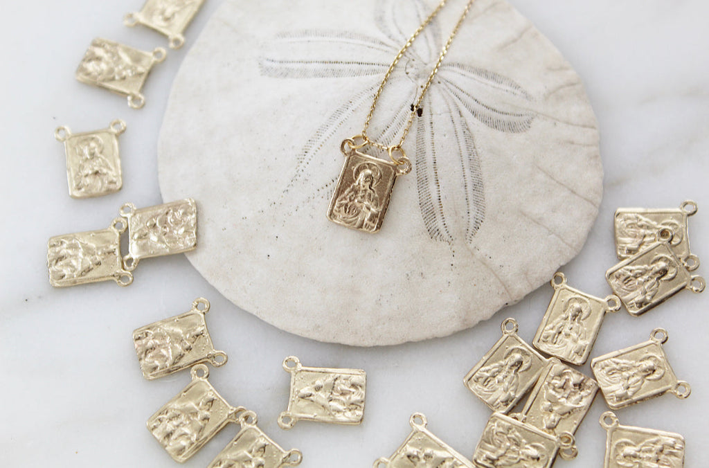 Scapular necklace with gold chain and rectangular pendant charms
