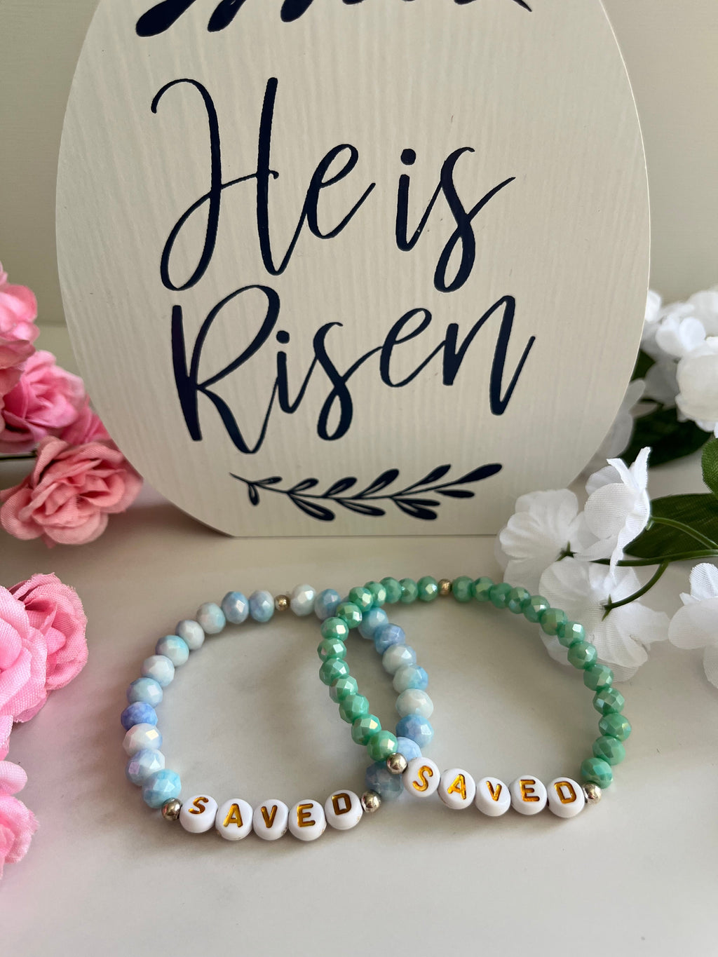 Mint and light blue beaded bracelets with gold accents and 'SAVED' letter beads