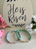 Mint and light blue beaded bracelets with gold accents and 'SAVED' letter beads