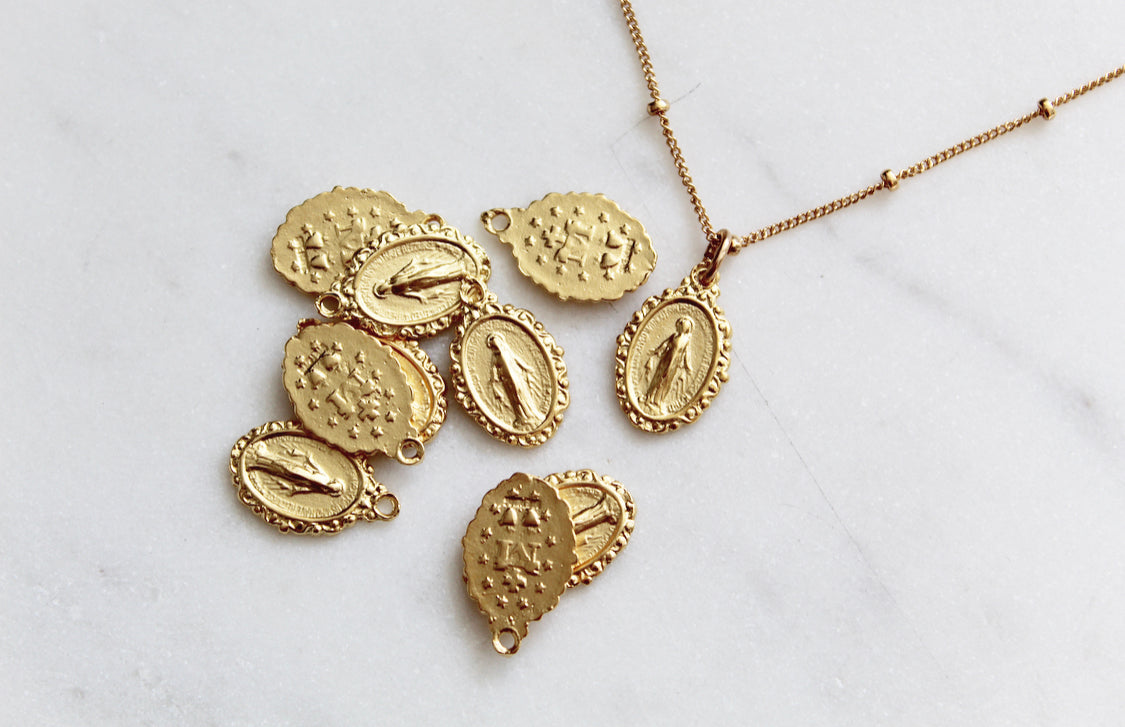 Gold-tone chain necklace with multiple oval Miraculous medal charms