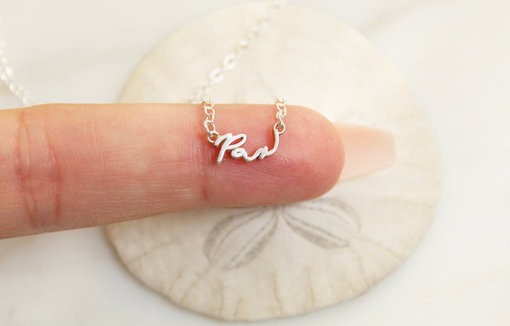 Sterling silver Pax necklace with centered cursive Pax charm on a fine chain