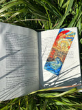 Handmade stained-glass style bookmark in a book, with colorful cathedral windows