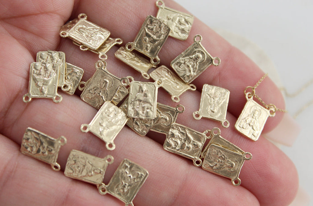 Scapular necklace with small rectangular gold-toned charms on chain