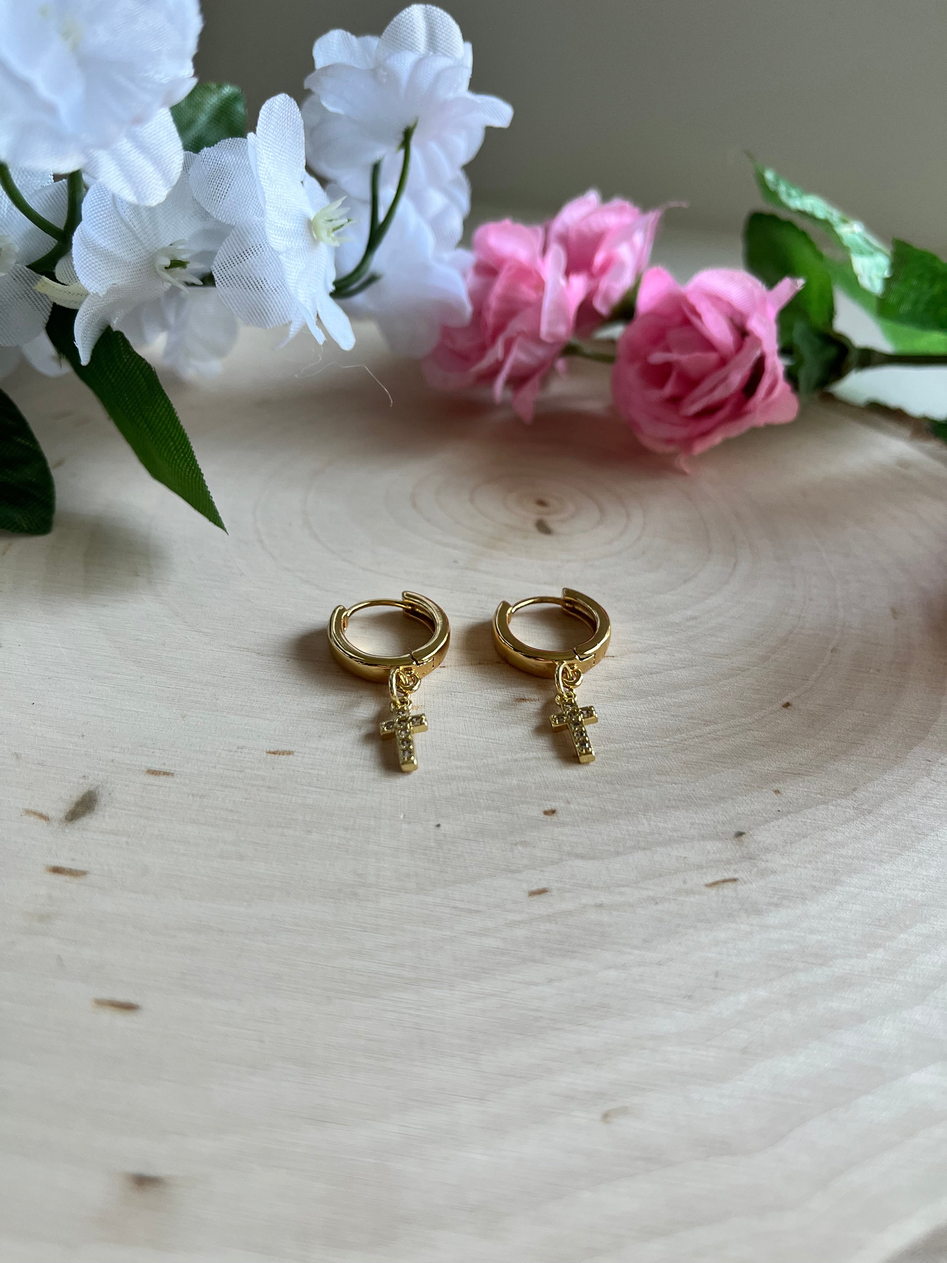 Gold hoop cross earrings with small cross charms, front view