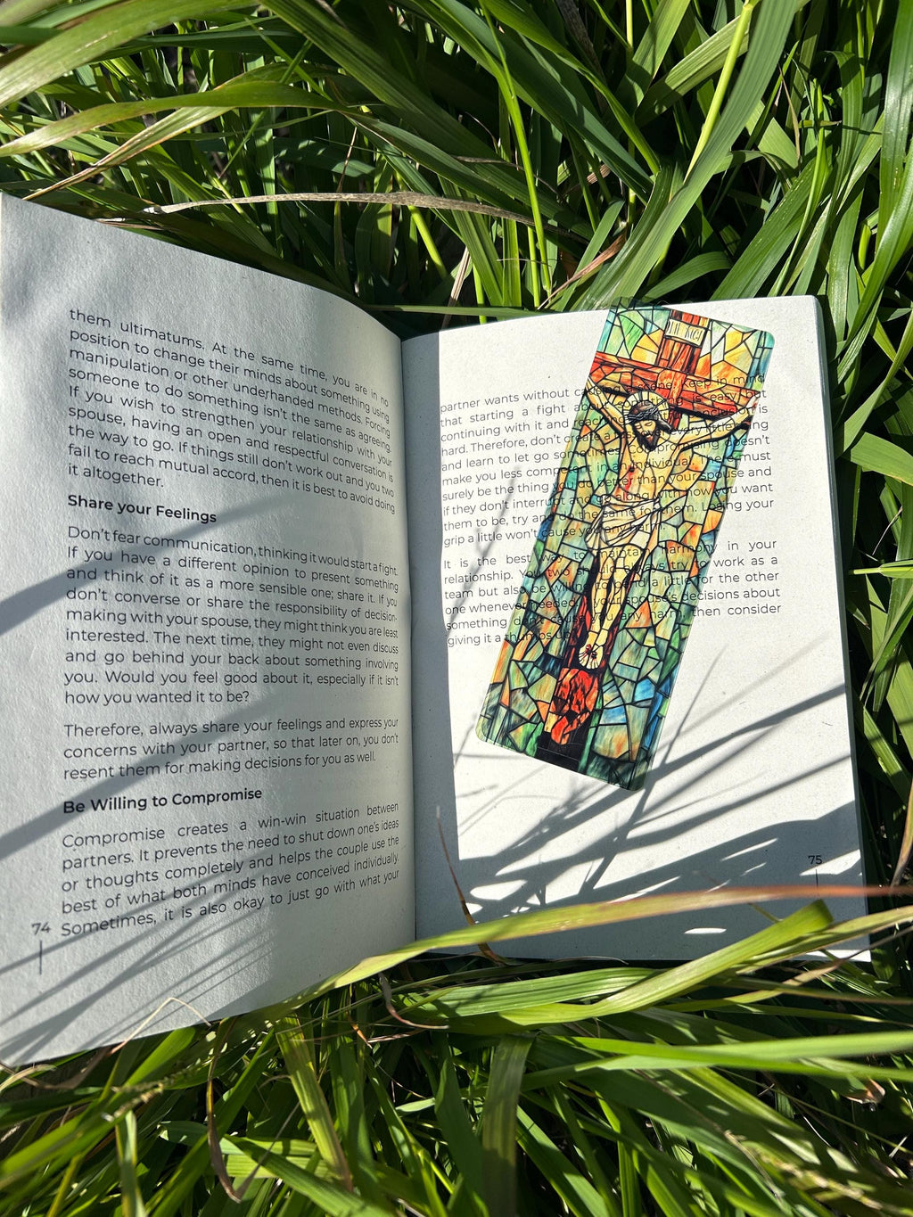 Handmade Jesus bookmark with stained-glass artwork, marking a book page