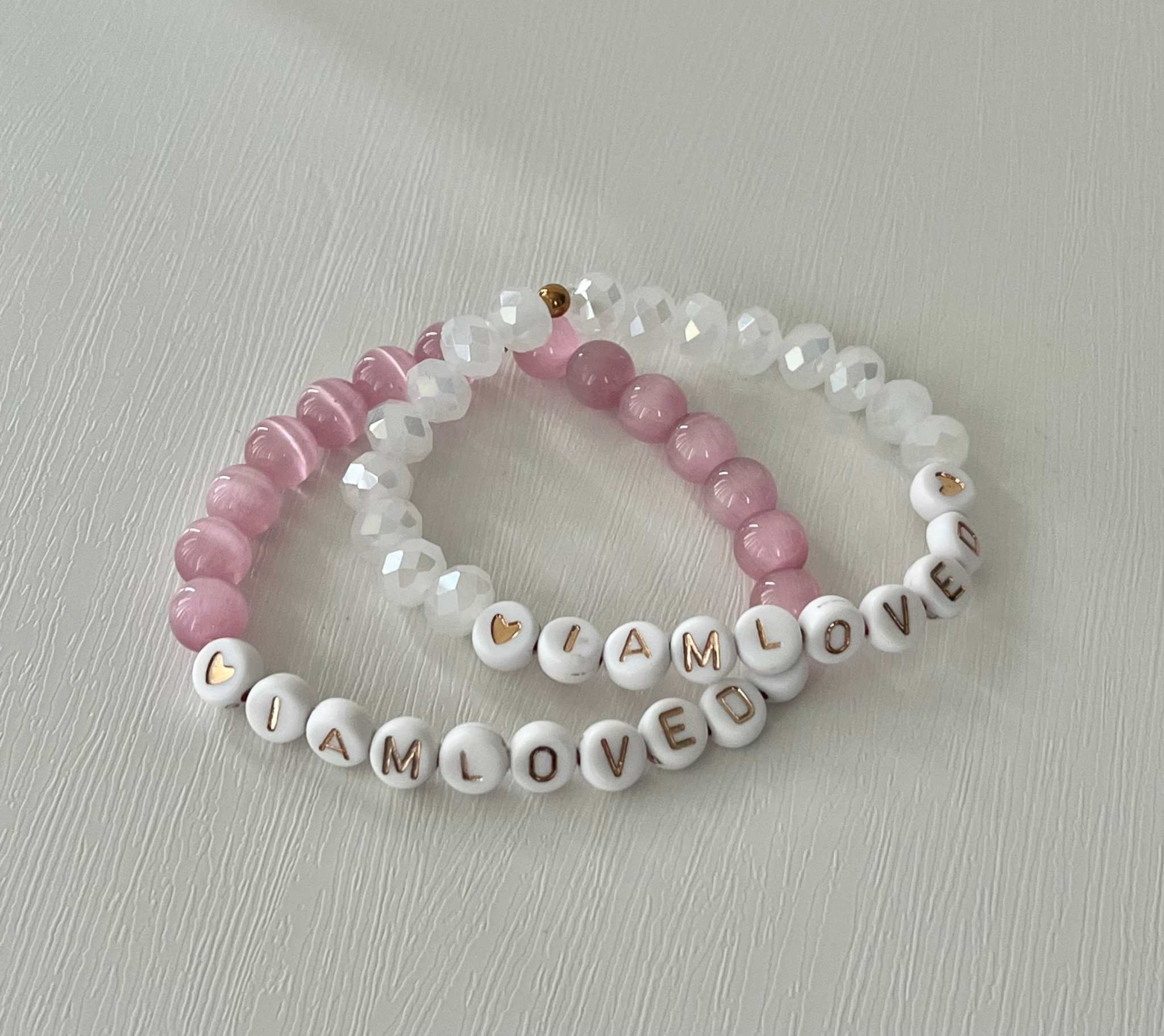 Pink and white beaded bracelet with faceted crystals and 'I AM LOVED' beads