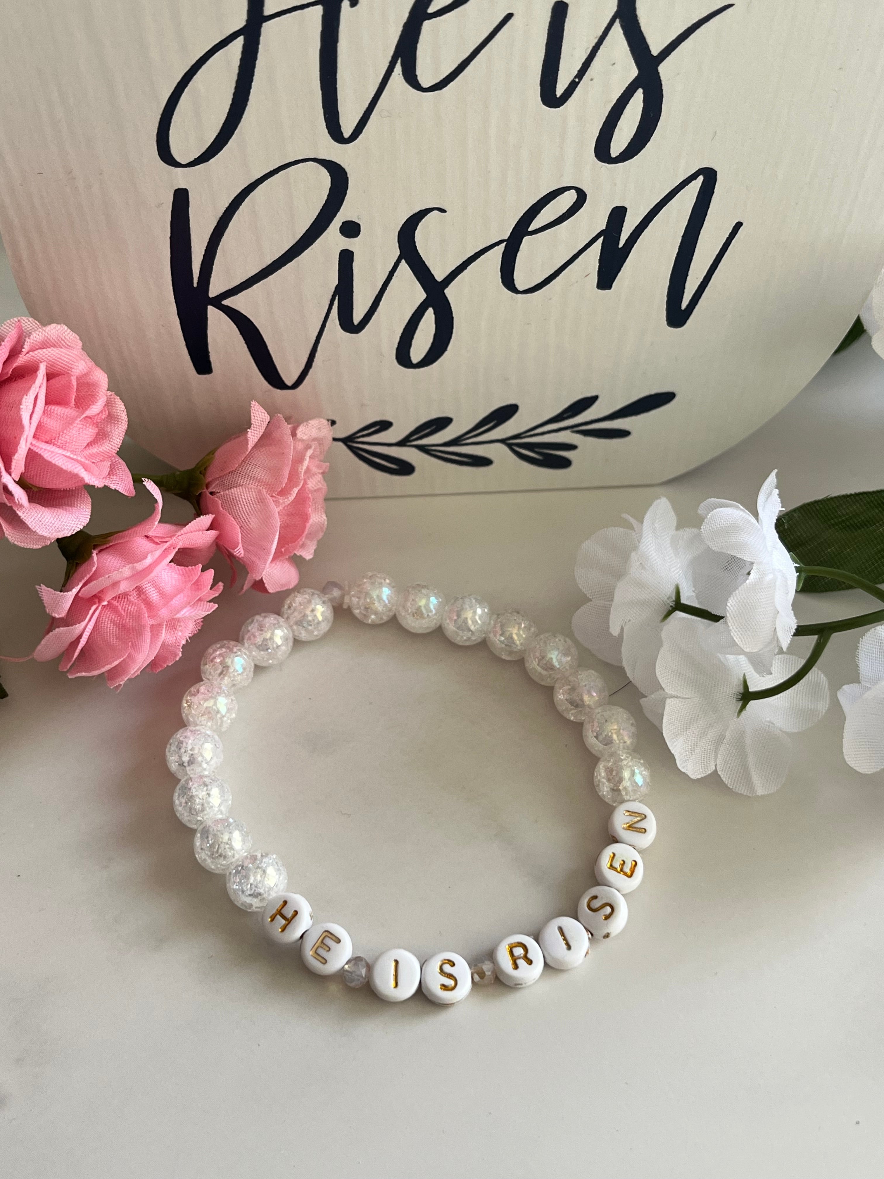 White pearl bead bracelet with “HE IS RISEN” letters and gold cross charm