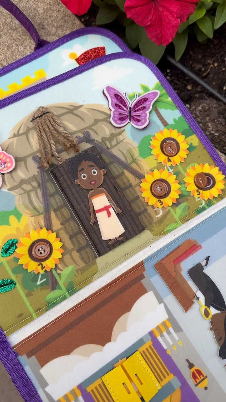 Busy book close-up with garden scene, butterfly sticker, sunflowers, and character figure