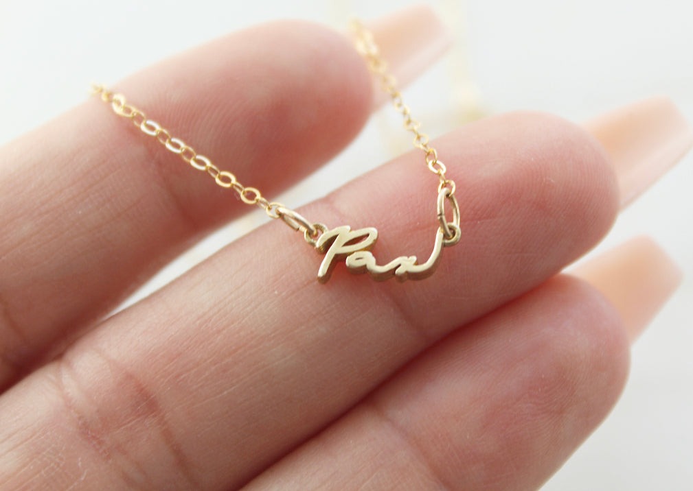 Pax bracelet with gold-tone chain and heart-shaped charm stamped Pax