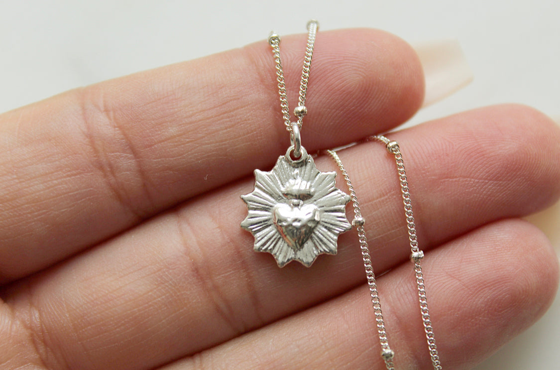 Sterling silver heart pendant necklace with scalloped frame, on a fine chain