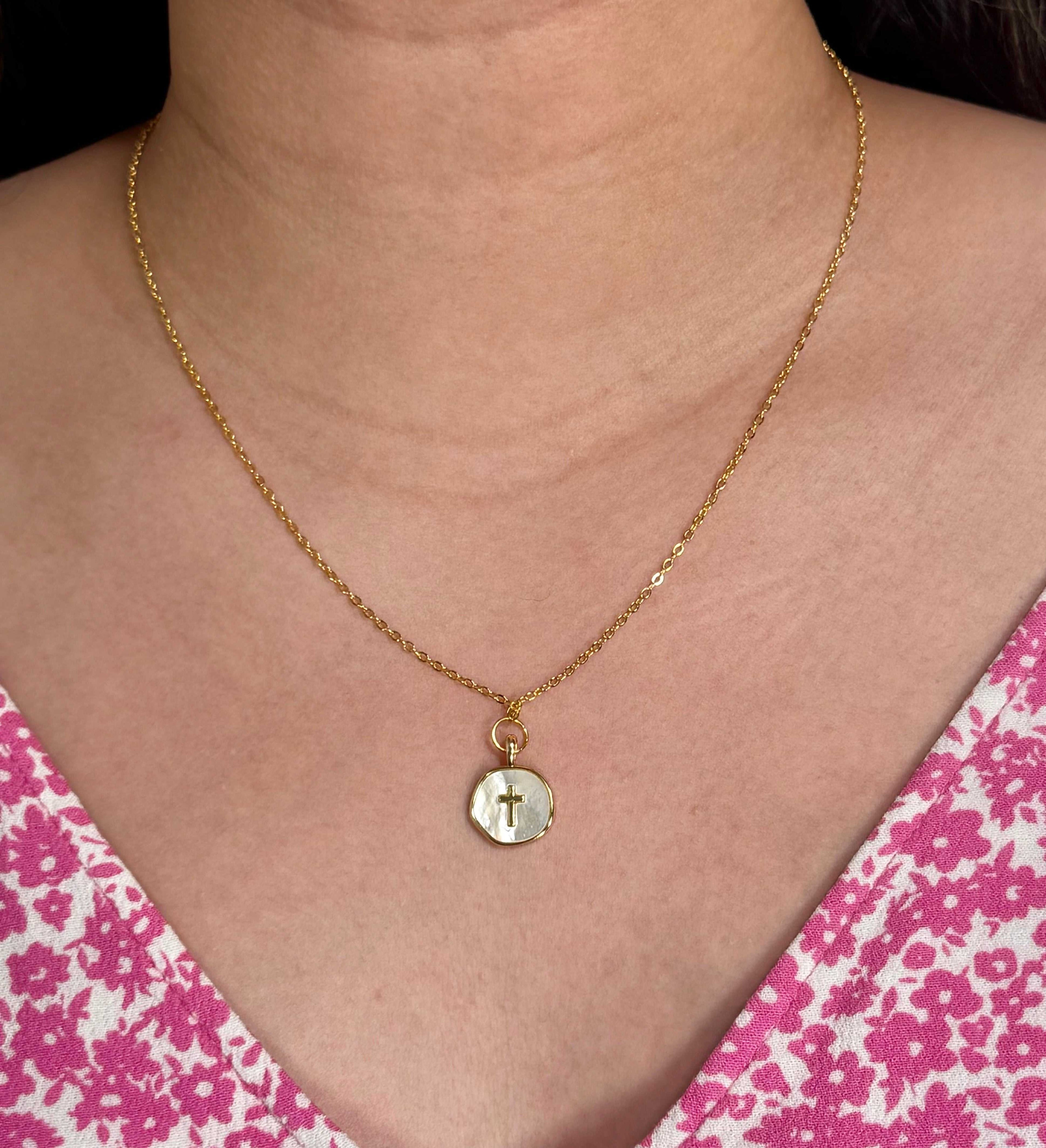 Gold cross pendant necklace worn on the neck, round charm with a cross