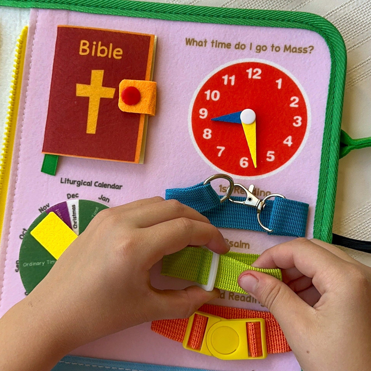 Felt busy book with Bible cross, liturgical clock, and Velcro strap pieces