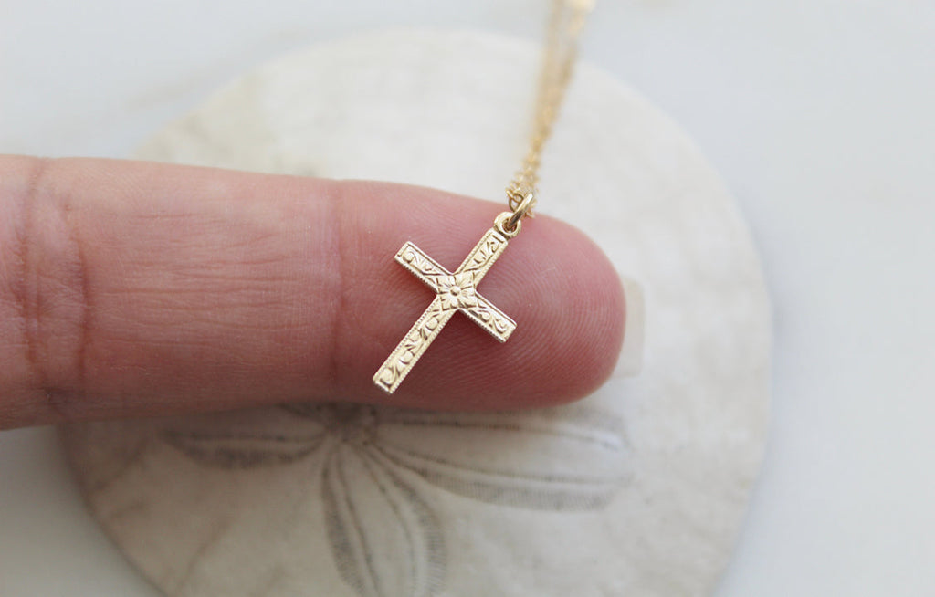 Gold cross pendant necklace with engraved cross design on chain