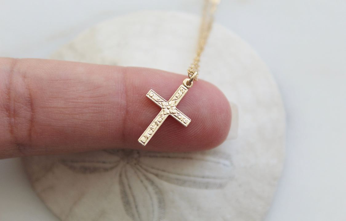 Gold cross pendant necklace with engraved cross design on chain