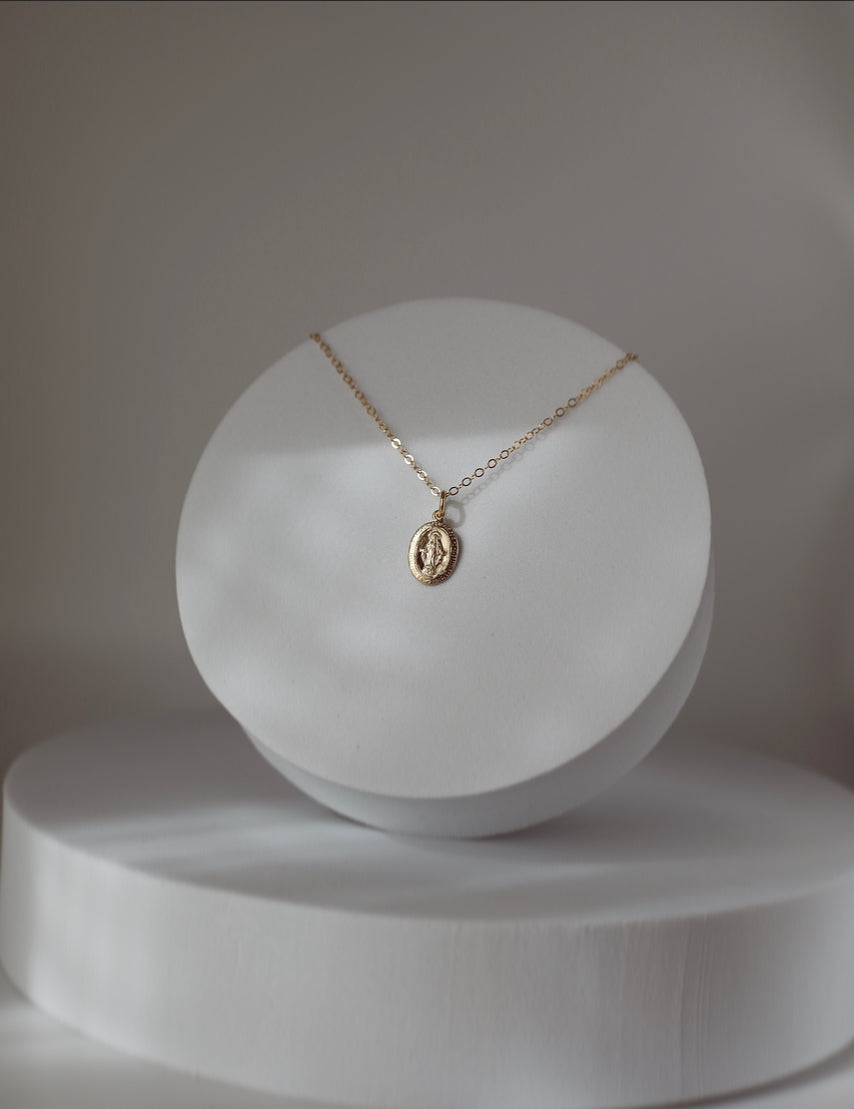 Silver-tone medal necklace with oval Virgin Mary-style pendant