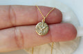 14k gold Holy Spirit necklace with round textured pendant on thin chain