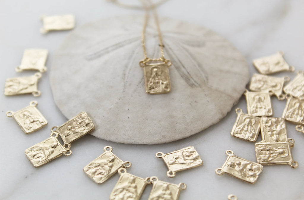 14k gold scapular necklace with multiple small saint charm pendants and chain