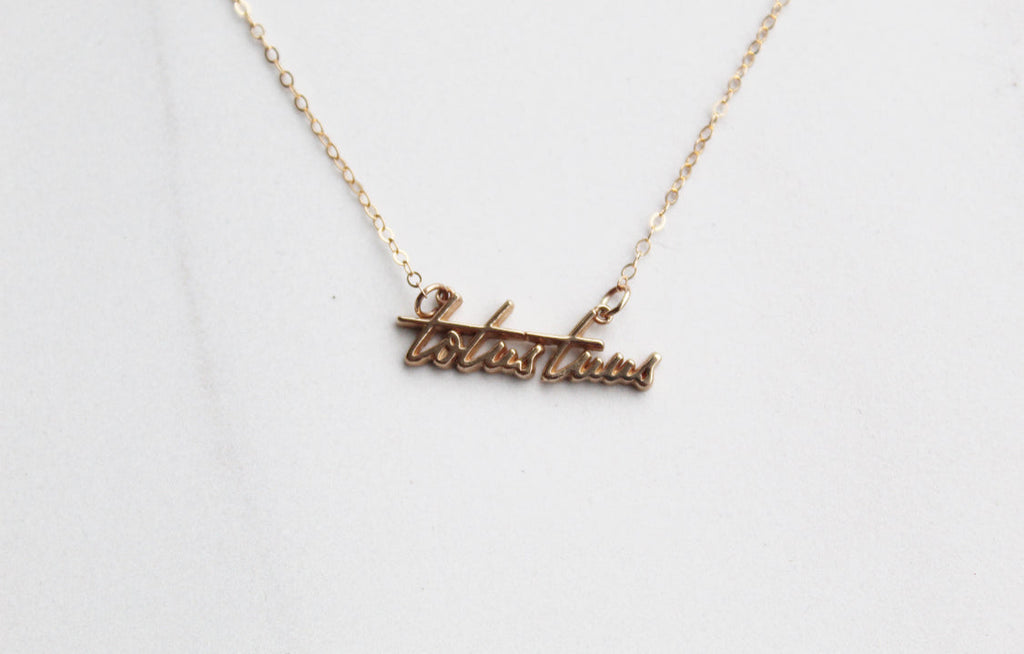 Gold-tone Totus Tuus script pendant necklace close-up