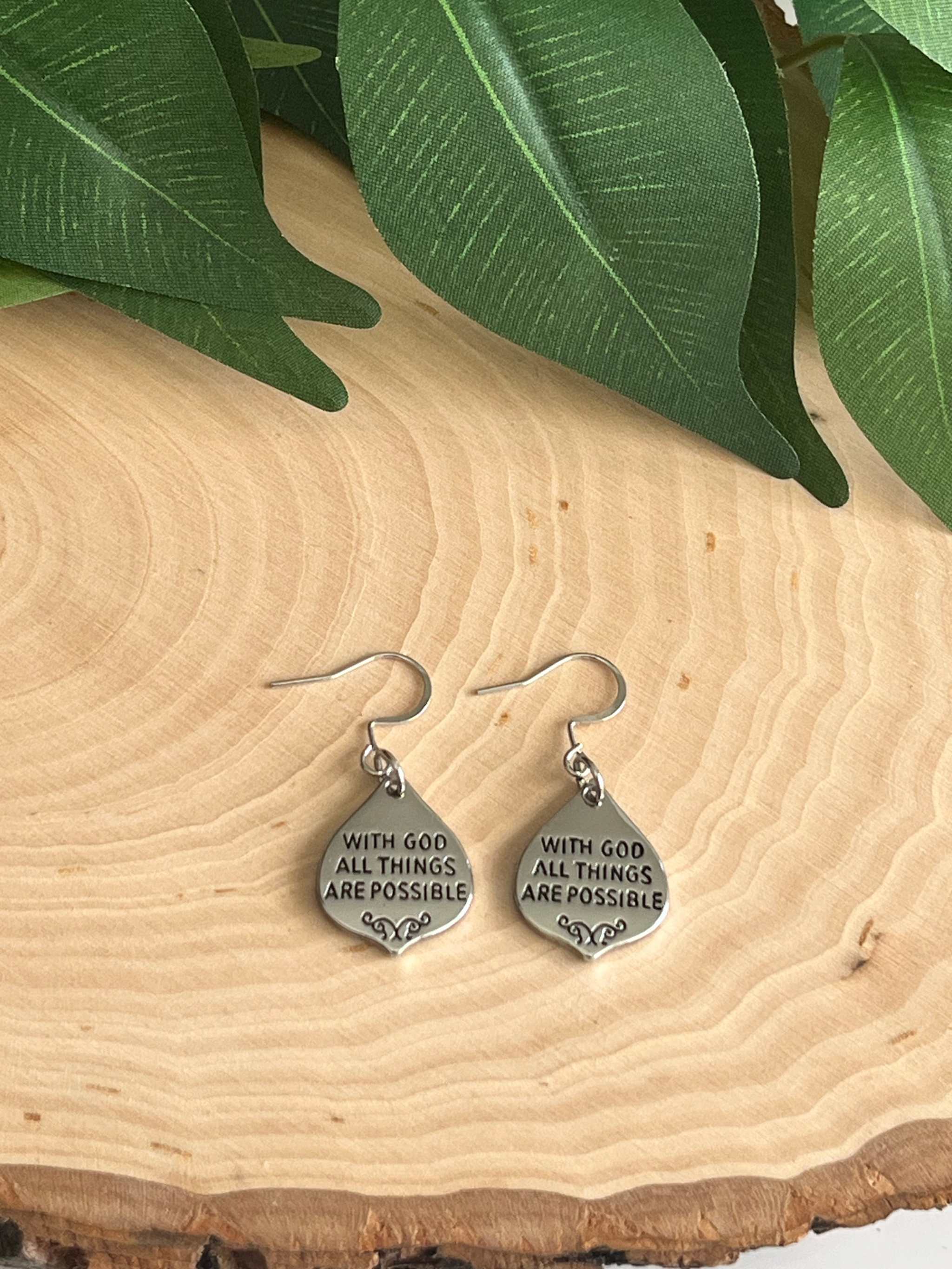 Silver dangle earrings with engraved “With God all things are possible” on round charms.