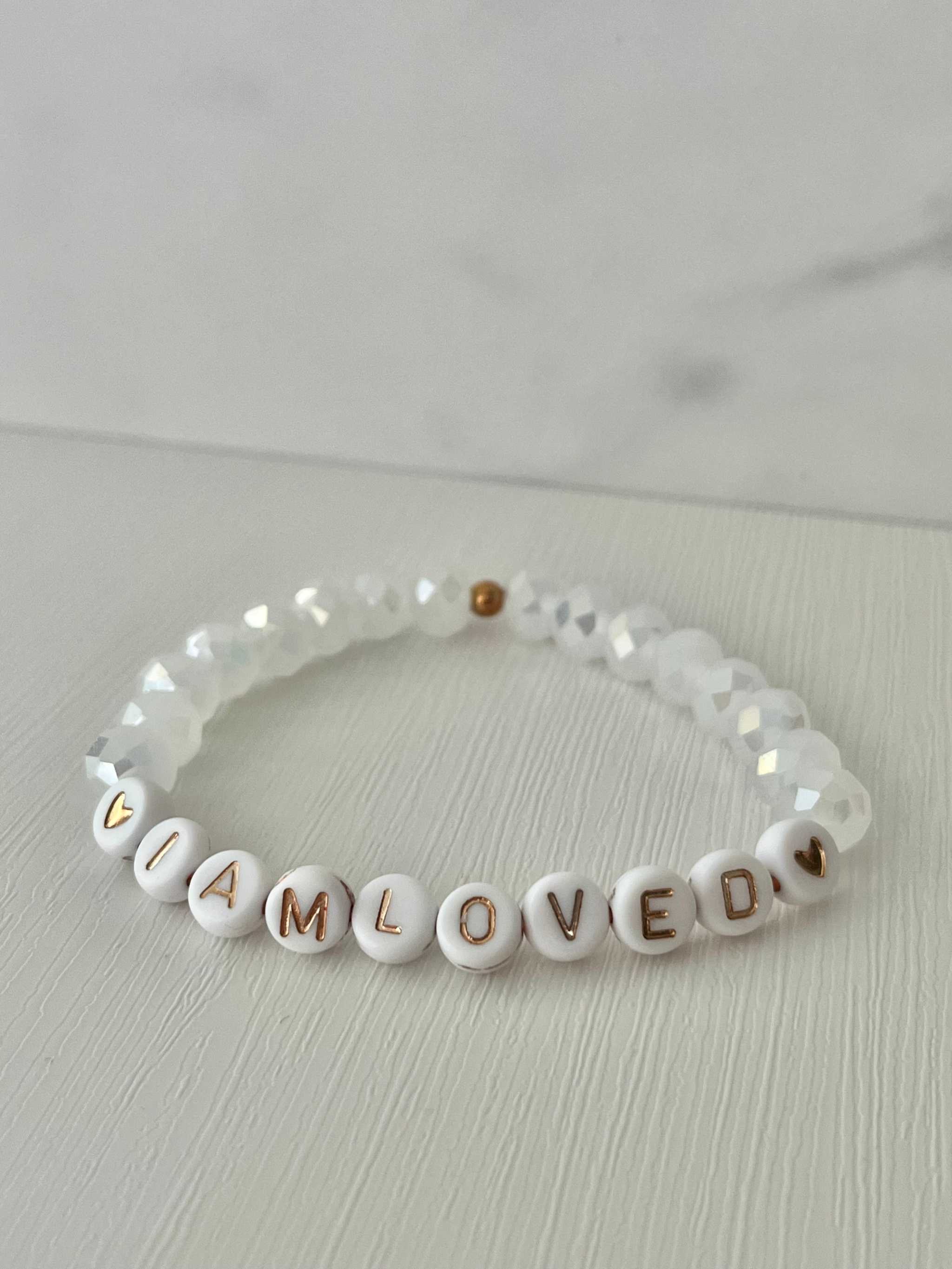 White beaded bracelet with faceted crystals and 'I AM LOVED' letter beads