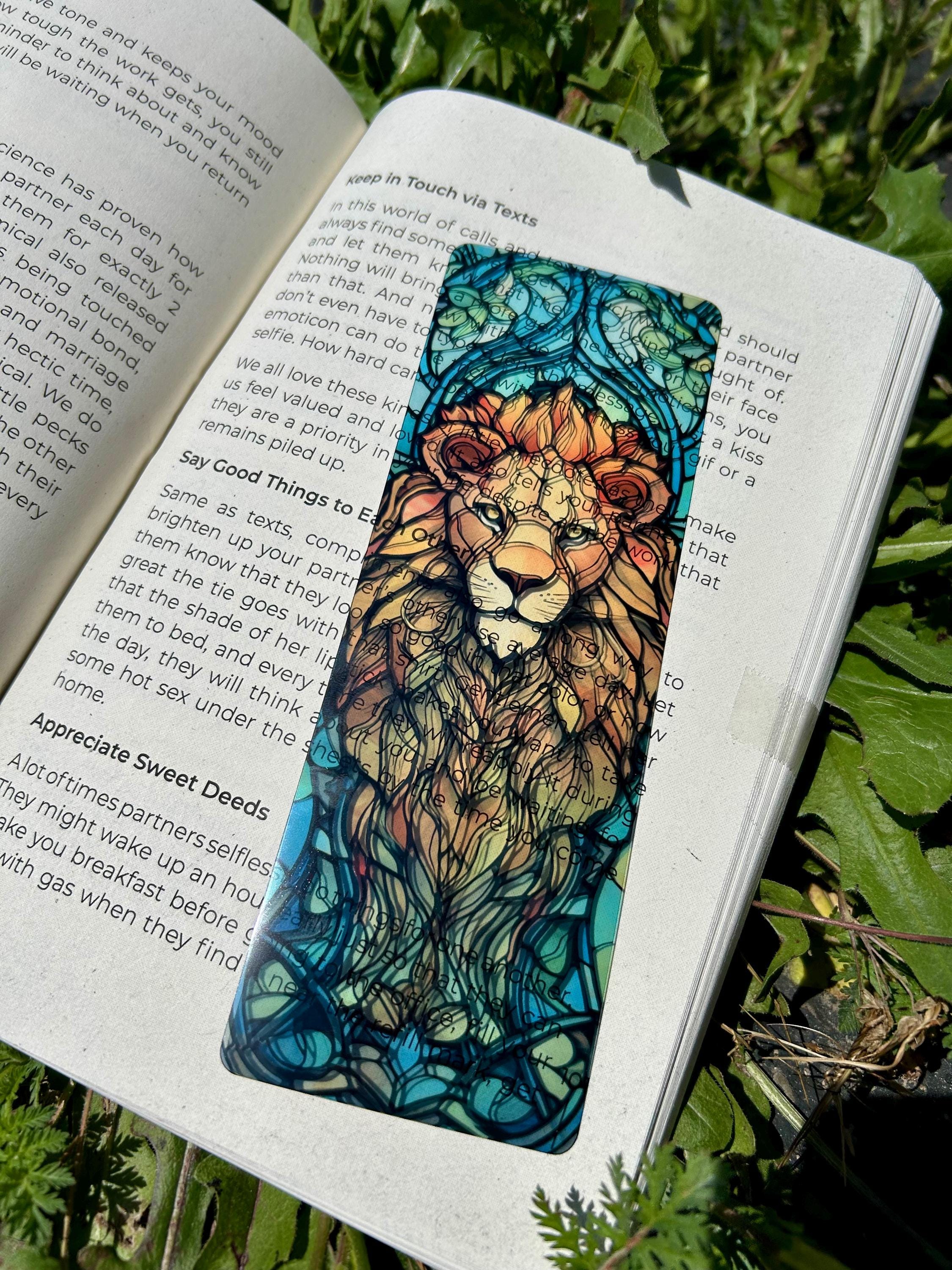 Lion face bookmark in teal with colorful mane, centered in an open page