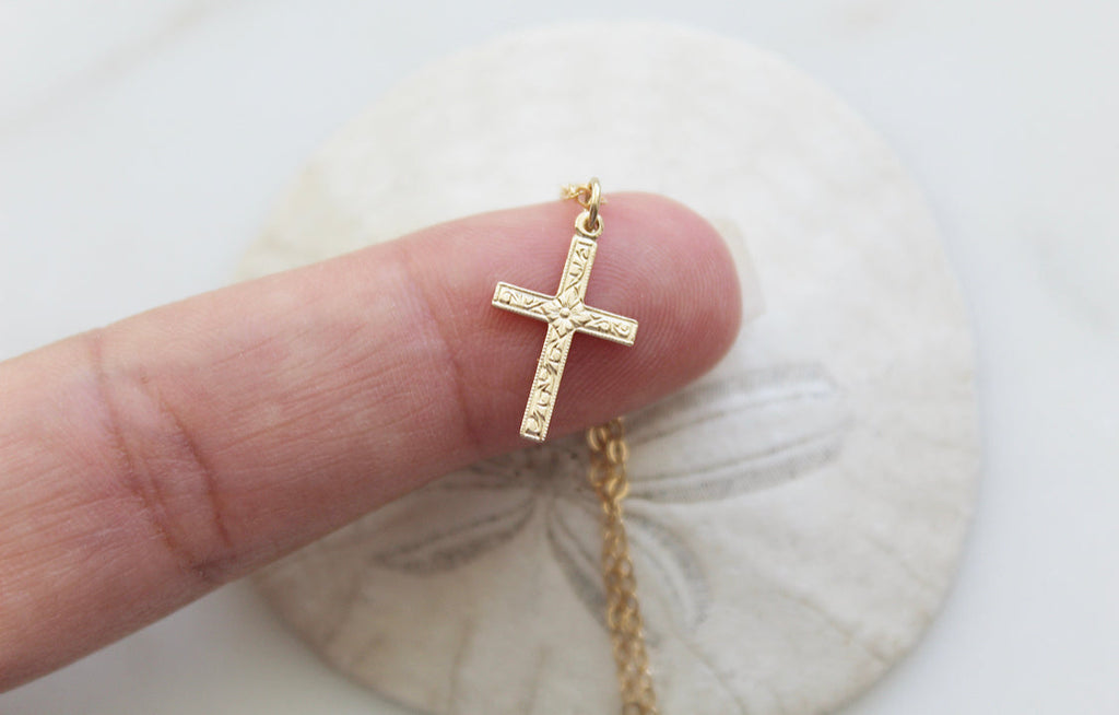 Gold cross pendant necklace with textured cross and chain loop