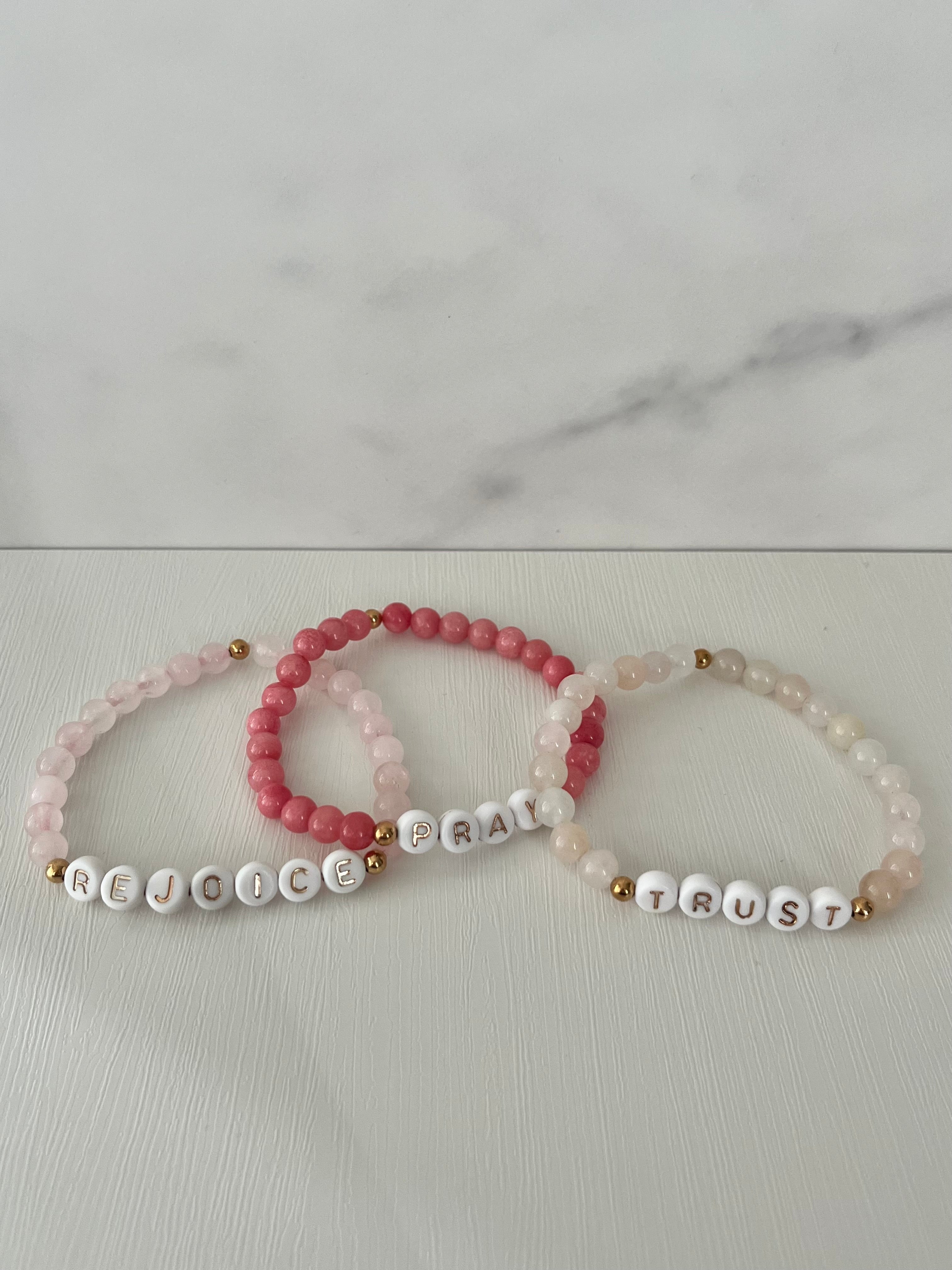 Beaded bracelet set: pink, red, and cream beads with Pray/Trust word charms