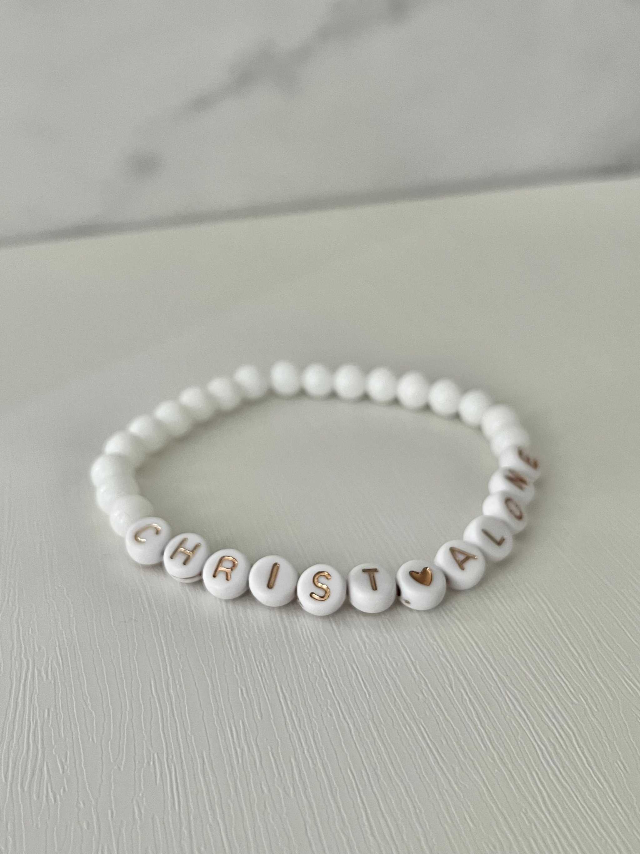 White bead bracelet with “Christ Alone” letter beads