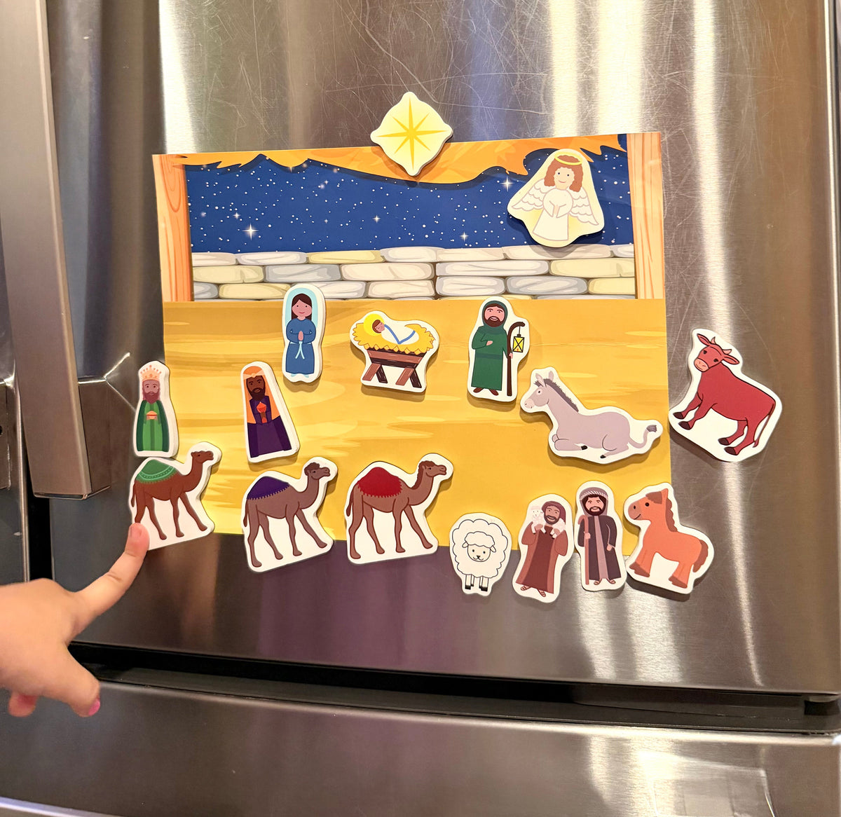 Nativity magnet set on refrigerator with character magnets and star