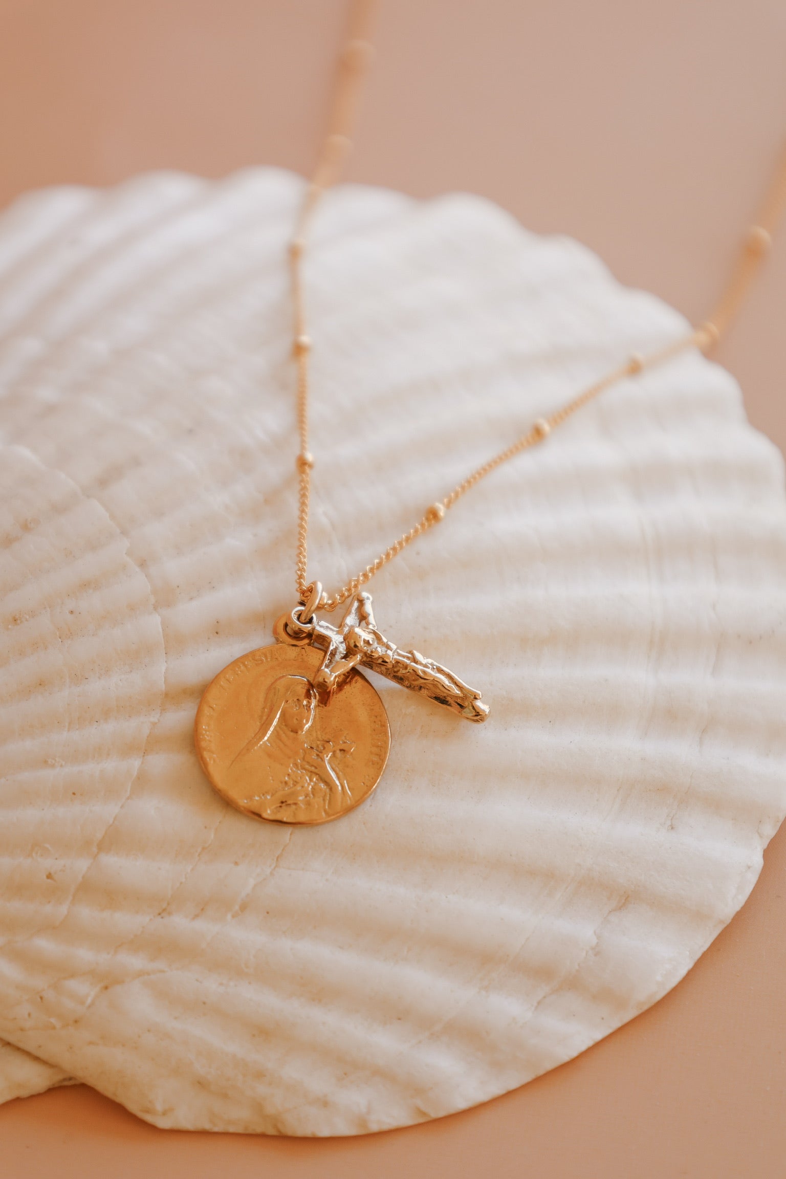 St. Therese of Lisieux crucifix necklace with gold-tone cross charm and pendant coin