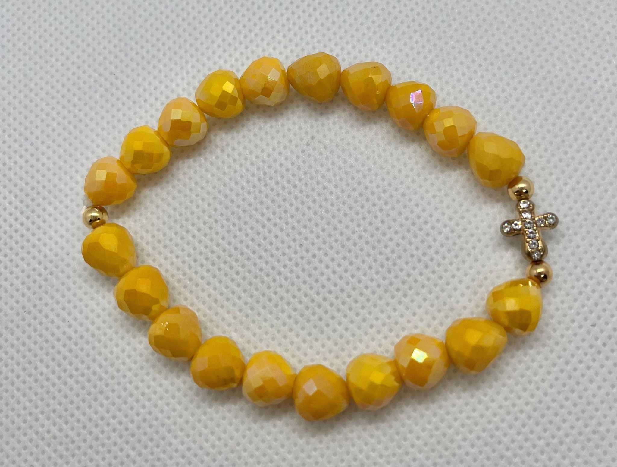 Beaded cross bracelet with yellow gemstone-style beads and small rhinestone cross