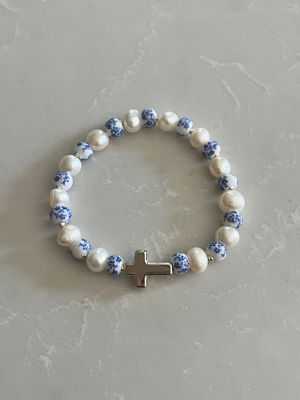 Pearl cross bracelet with blue speckled beads, white pearls, flat gold-tone cross