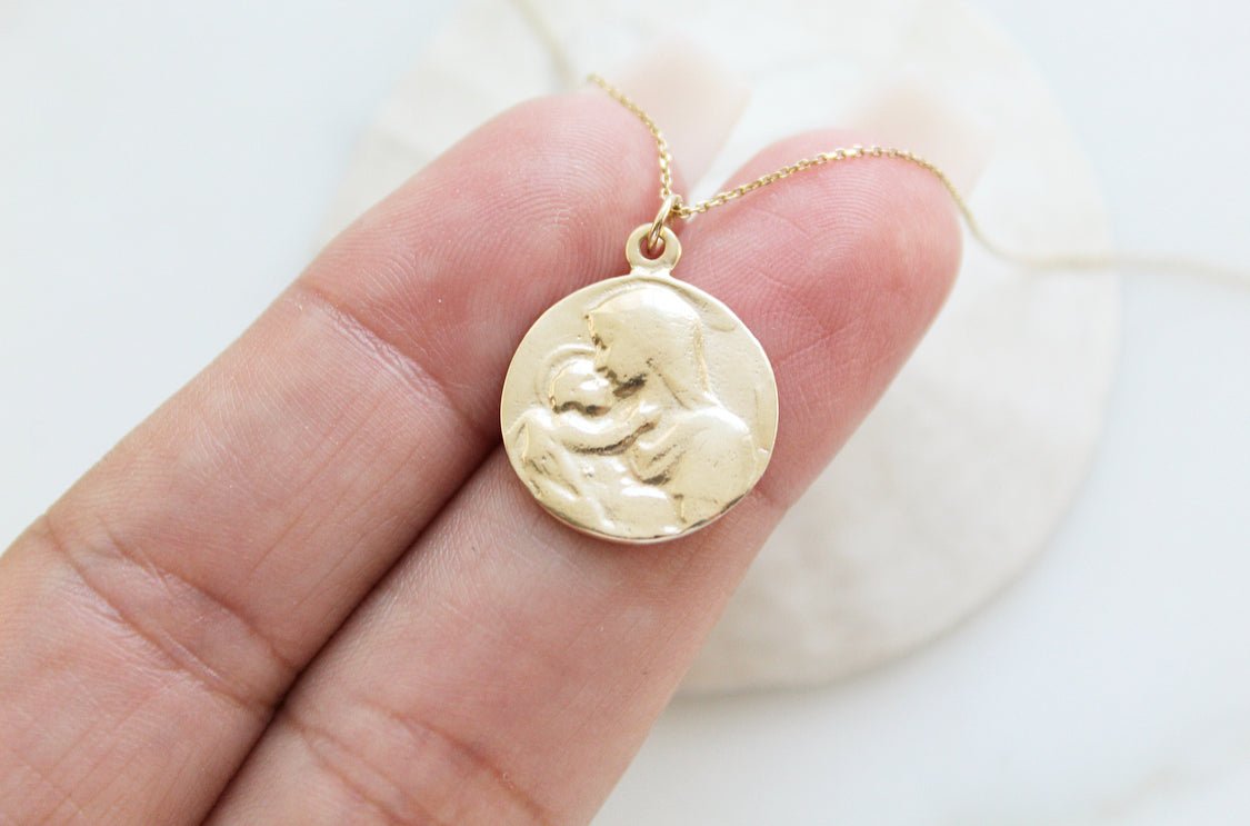 14k gold medallion pendant necklace with Jesus and Mary relief, front view on chain