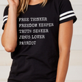 Black crewneck graphic T-shirt with striped sleeves and FREE THINKER text